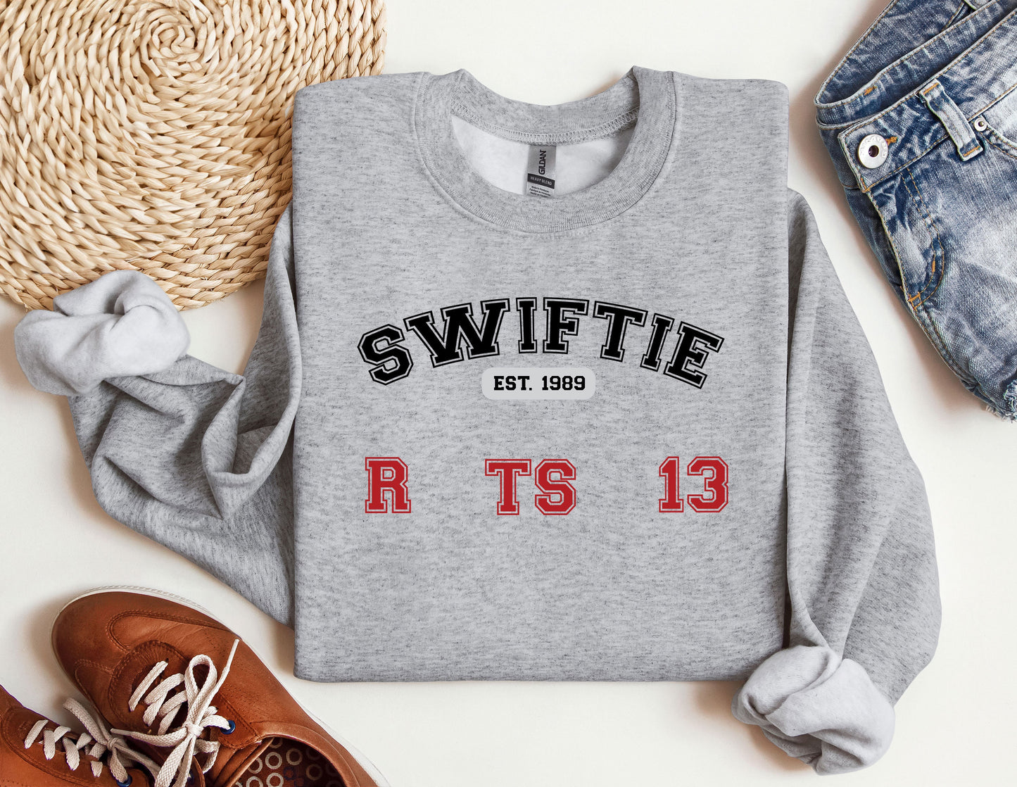 a sweater with swiffie on it next to a pair of shoes