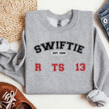 a sweater with swiffie on it next to a pair of shoes