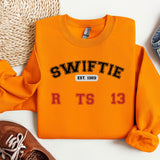 a pair of shoes and a sweater on a white surface