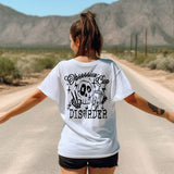 a woman walking down a road with her arms outstretched