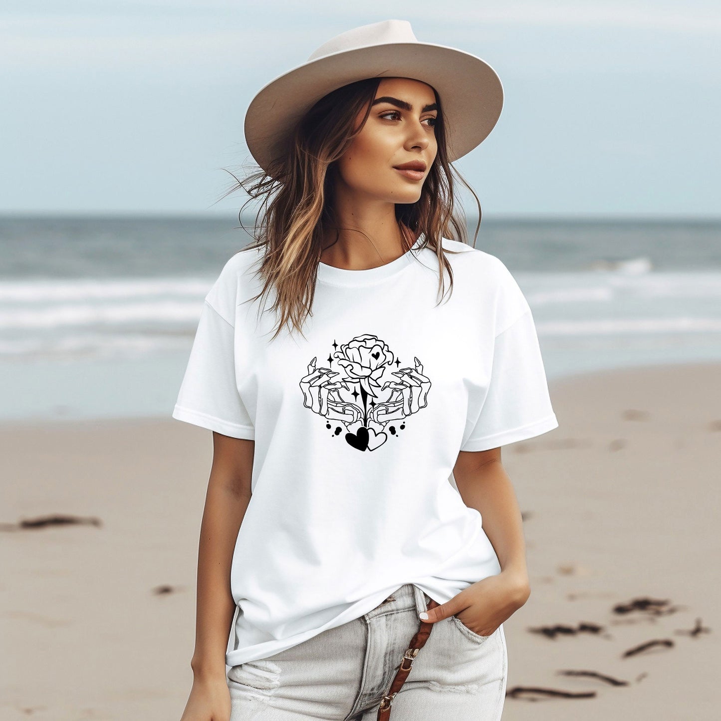 a woman wearing a white t - shirt and hat on the beach