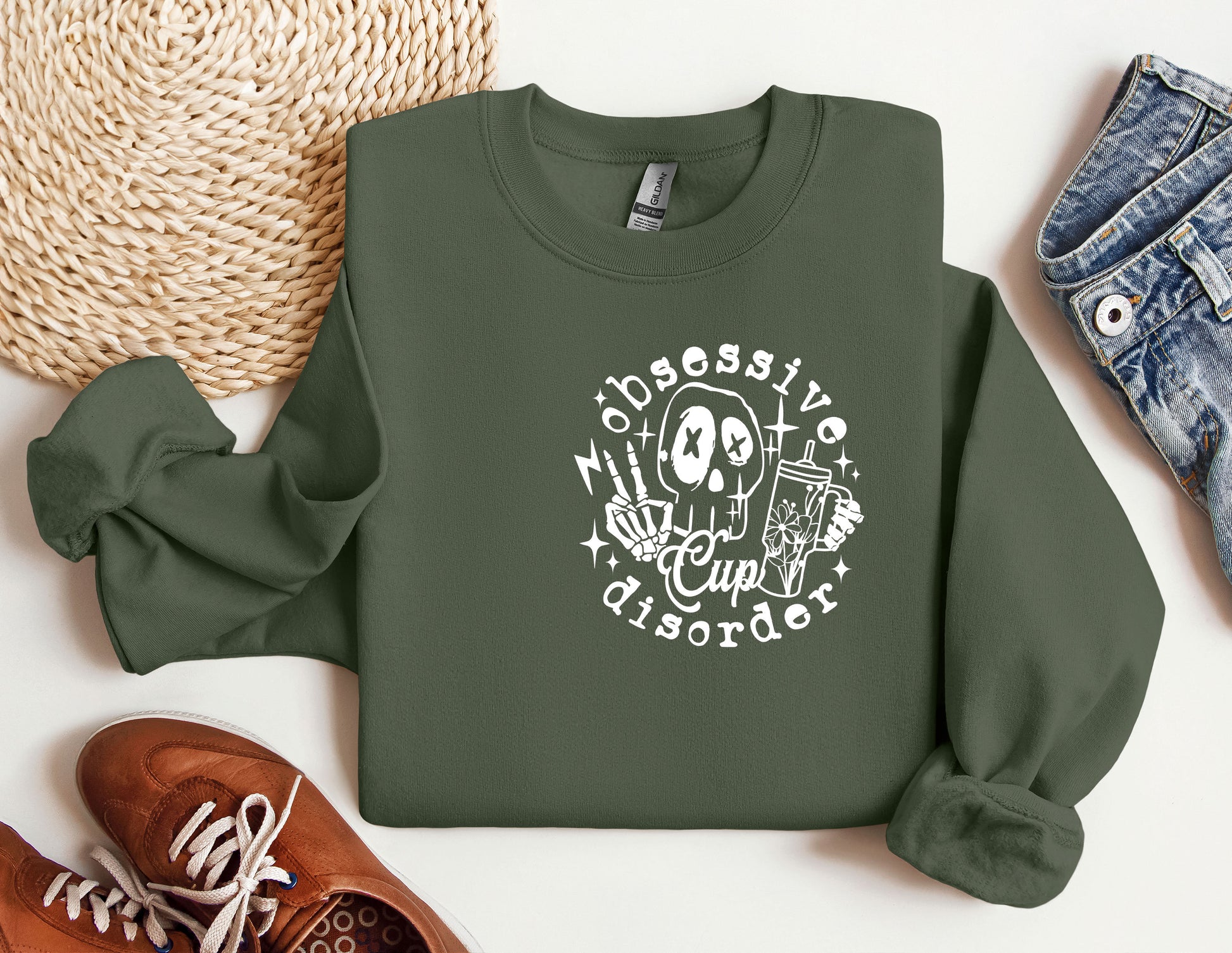 a green sweatshirt with a skeleton on it next to a pair of shoes