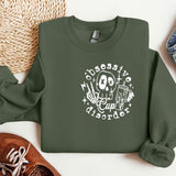 a green sweatshirt with a skeleton on it next to a pair of shoes