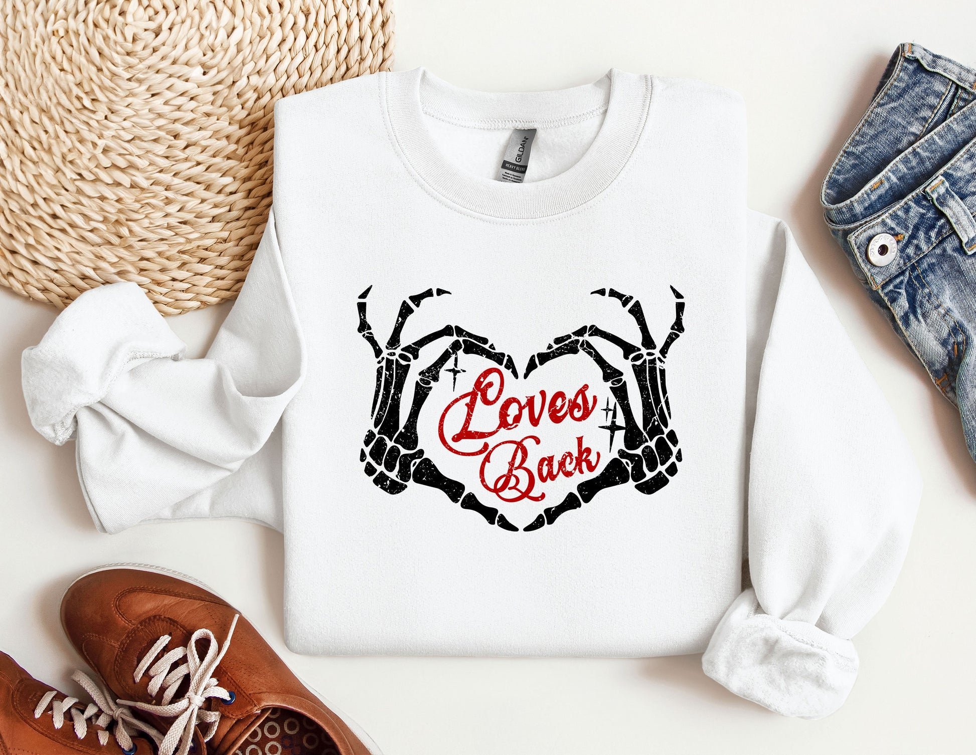 a pair of shoes, a pair of jeans, and a sweatshirt with the words