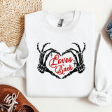 a pair of shoes, a pair of jeans, and a sweatshirt with the words