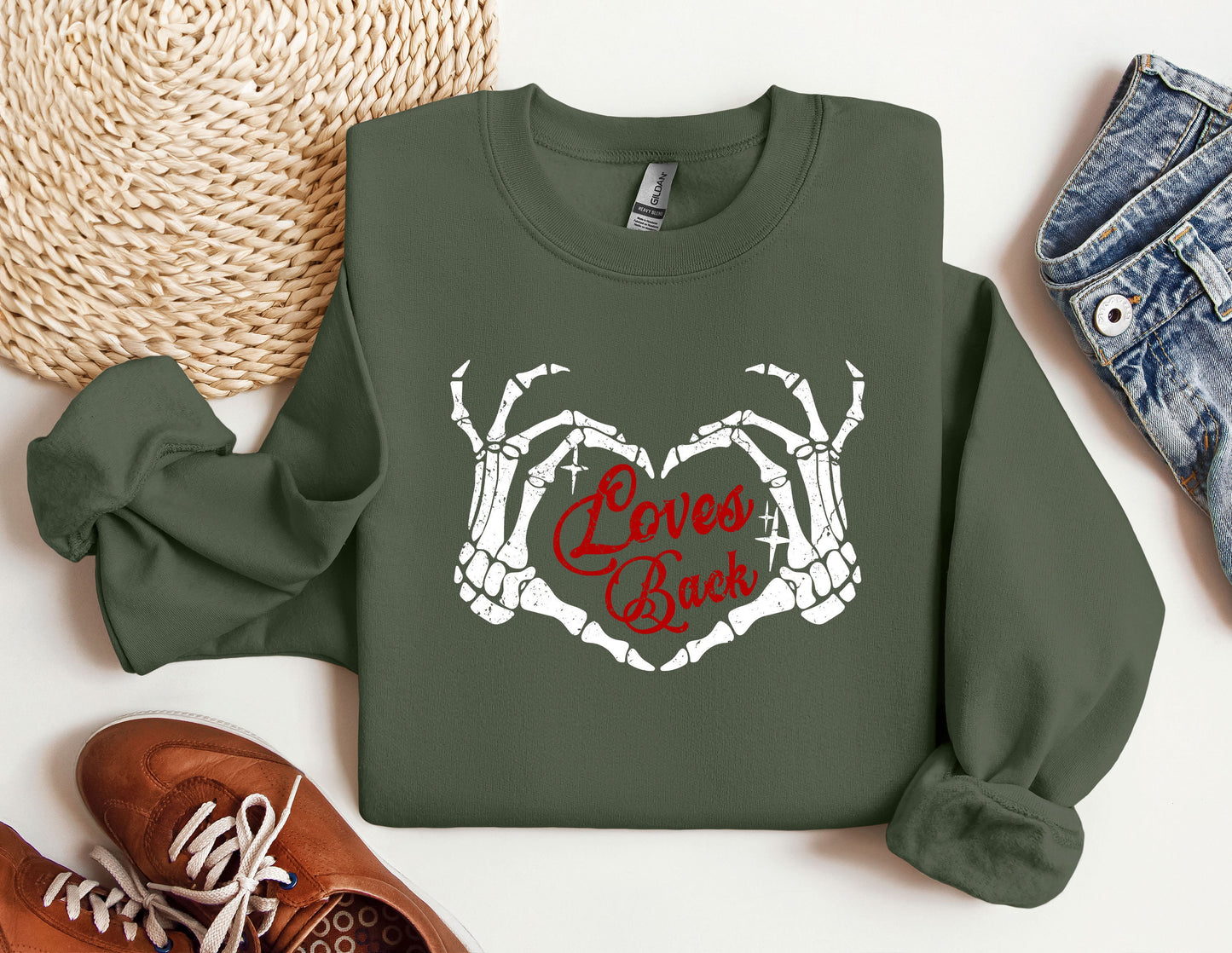 a green sweatshirt with the words love&#39;s back printed on it