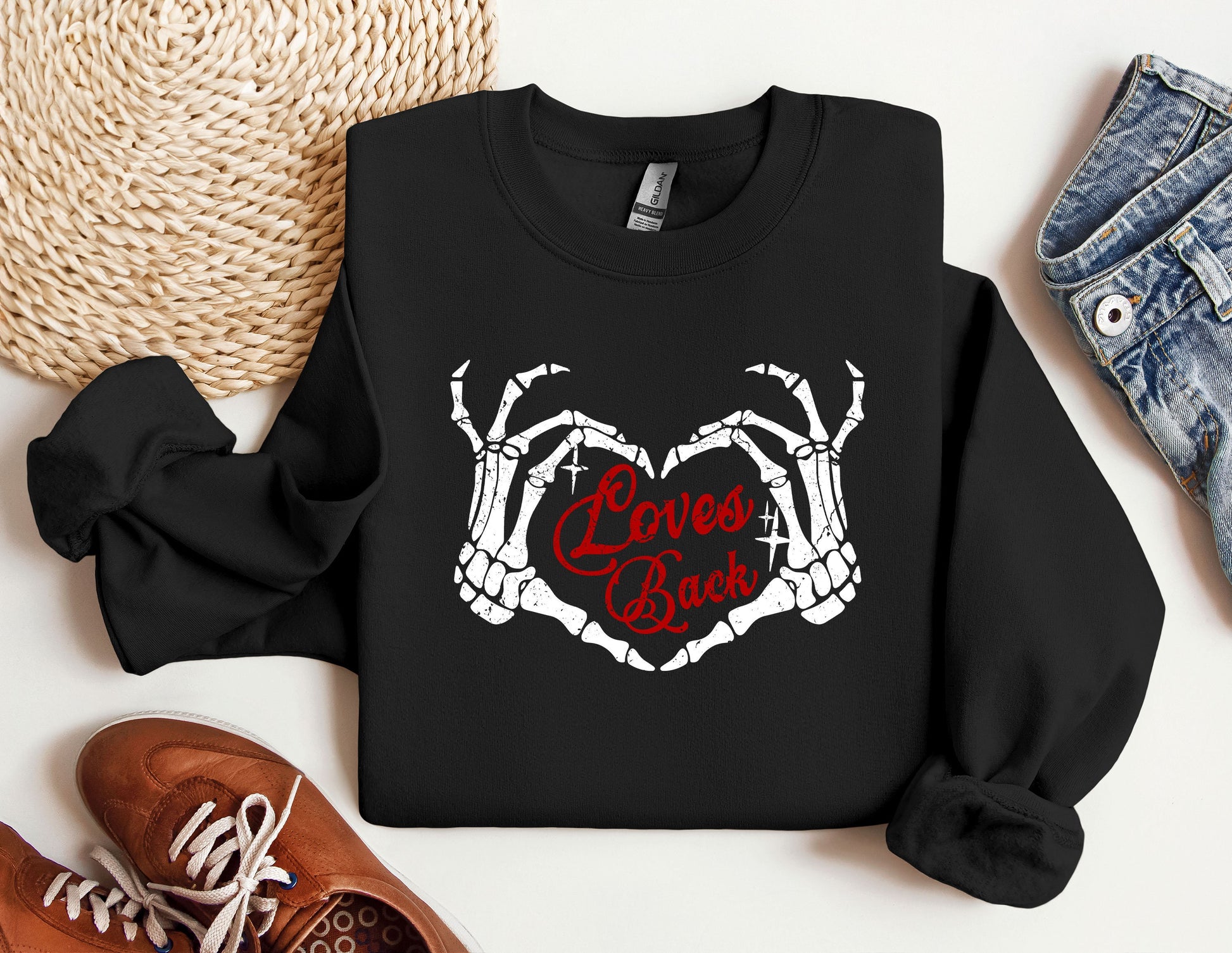 a black sweatshirt with the words love is back on it next to a pair of