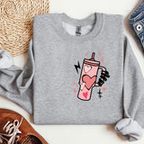 a gray sweatshirt with a pink drink on it