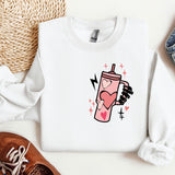 a white shirt with a pink drink on it