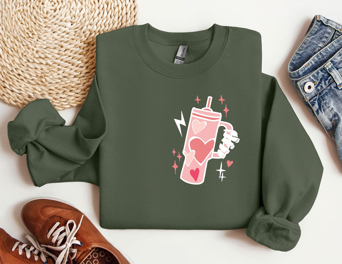 a green sweatshirt with a pink drink on it