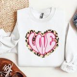 a white sweater with a pink heart on it