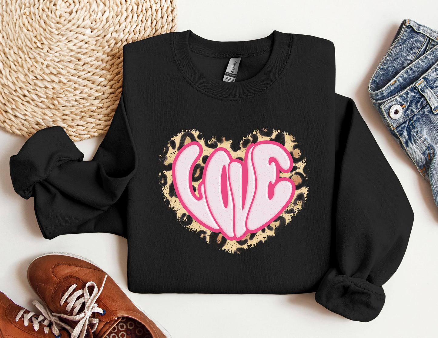 a black sweatshirt with a pink heart on it