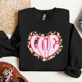a black sweatshirt with a pink heart on it