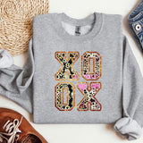a gray sweatshirt with a leopard print on it
