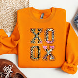 a pair of shoes and an orange shirt with the words xoxo on it