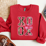 a red shirt with leopard print on it next to a pair of shoes