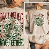 a woman wearing a long sleeved shirt with a skeleton on it