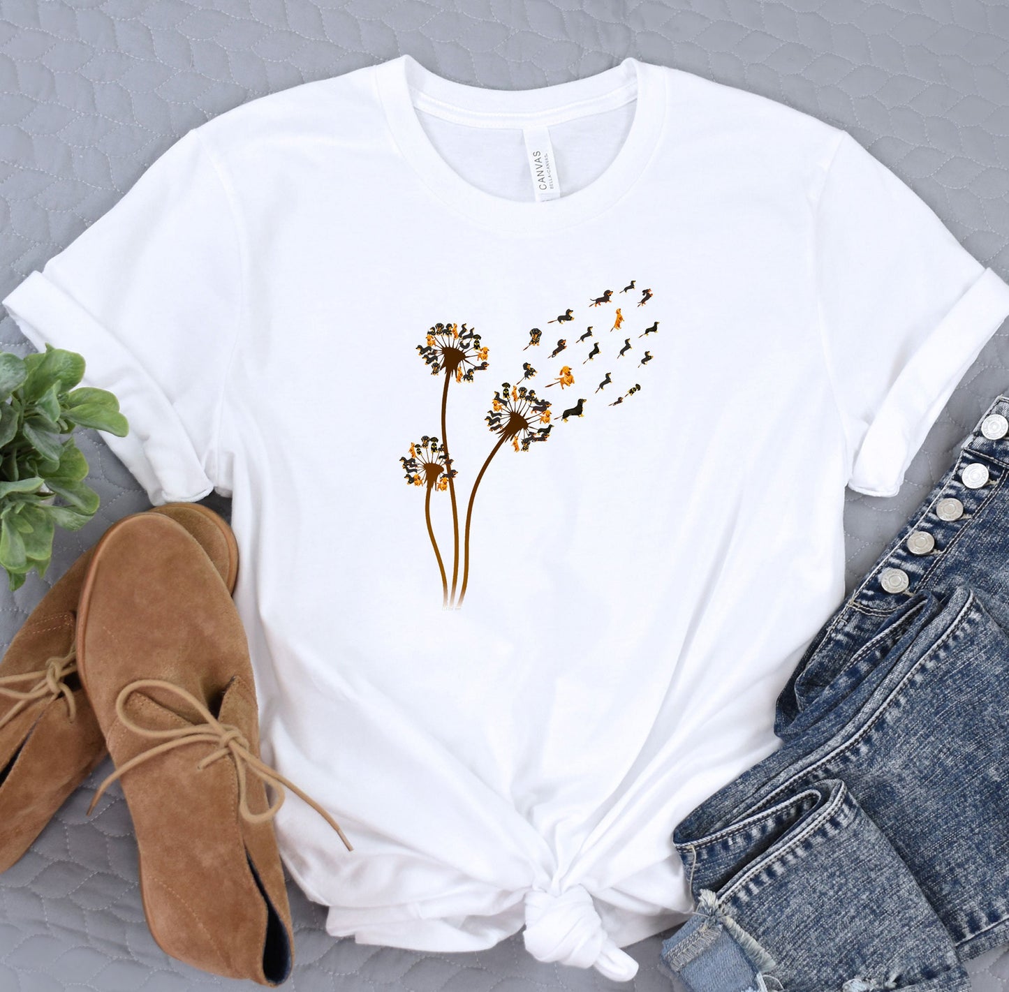 a white t - shirt with a picture of a dandelion on it