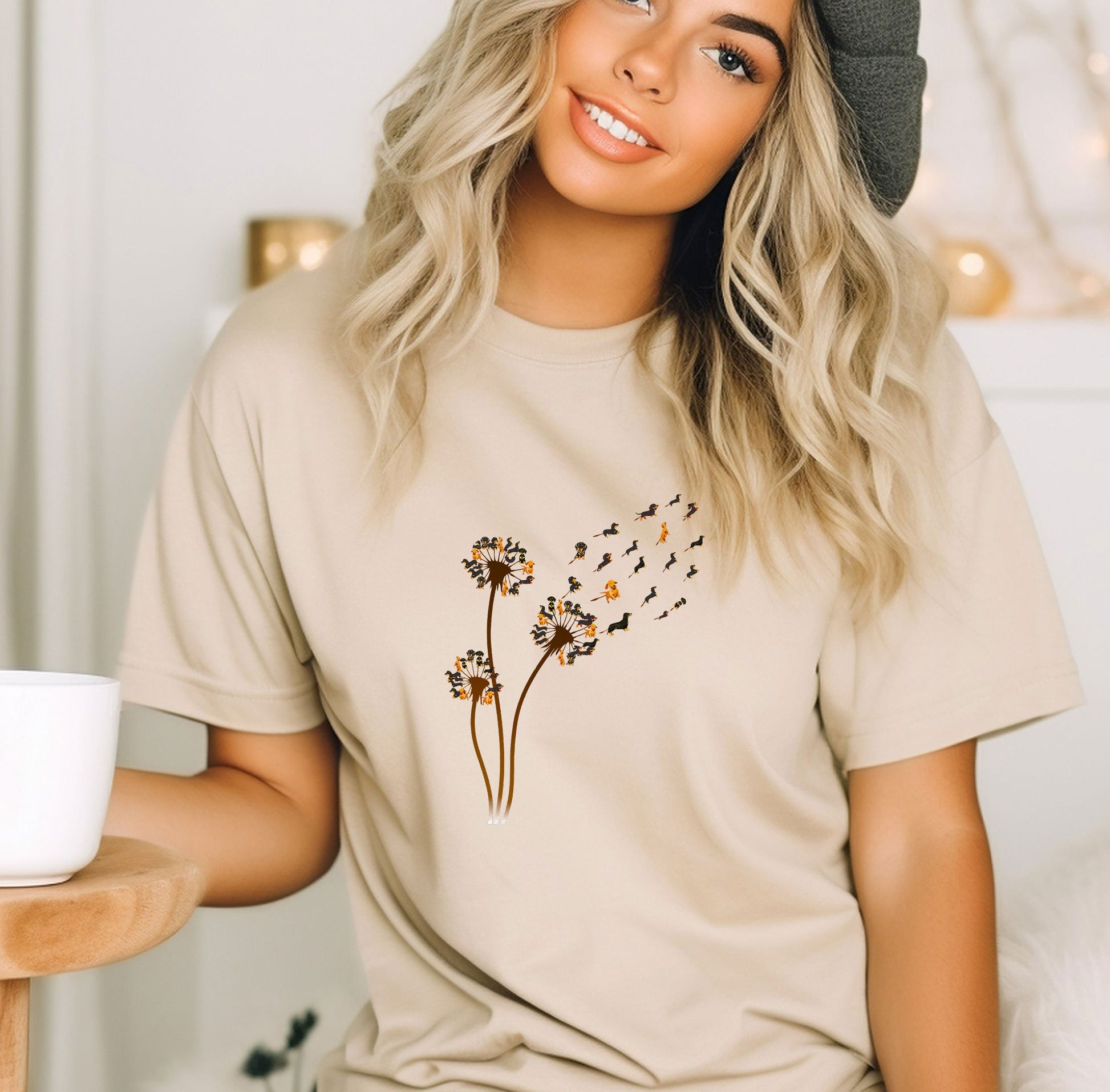 a woman wearing a t - shirt with a dandelion design