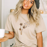 a woman wearing a t - shirt with a dandelion design