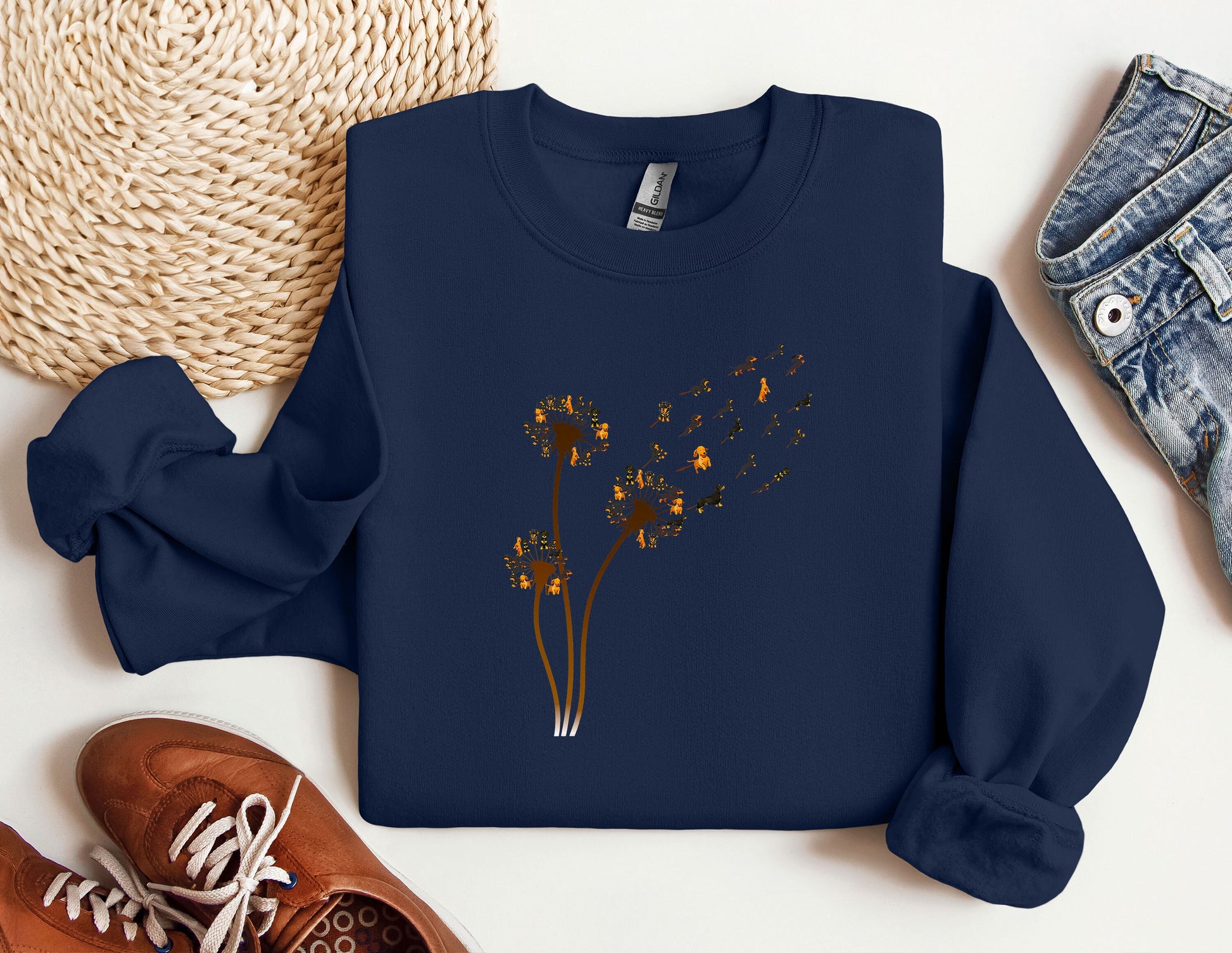 a blue sweatshirt with a picture of a dandelion on it