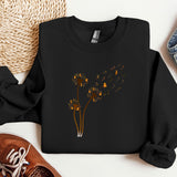 a black sweatshirt with yellow flowers on it