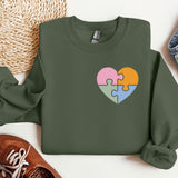 a green sweater with a puzzle heart on it