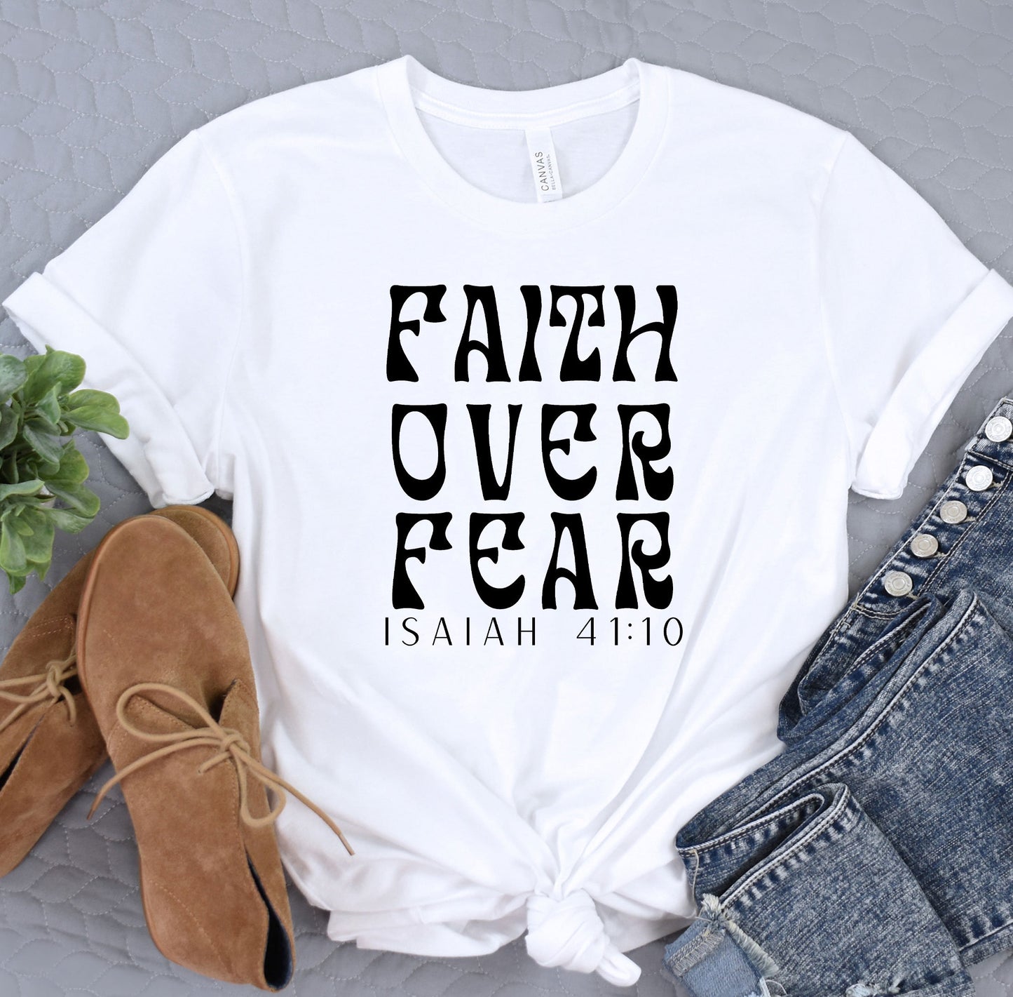 a t - shirt with the words faith over fear printed on it