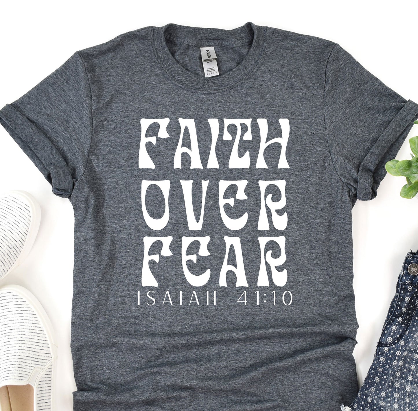 a t - shirt with the words faith over fear printed on it