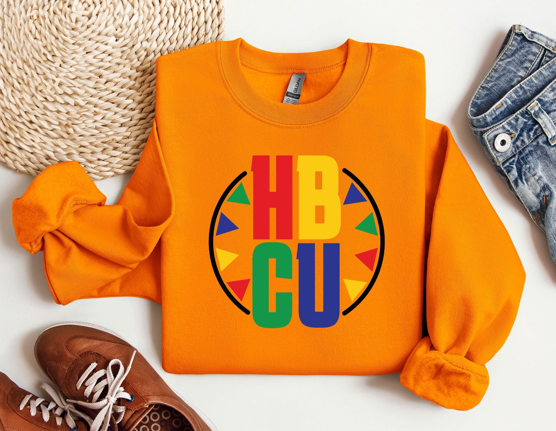 an orange shirt with the word hbcu on it next to a pair of