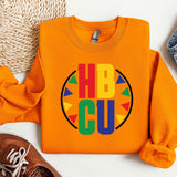 an orange shirt with the word hbcu on it next to a pair of