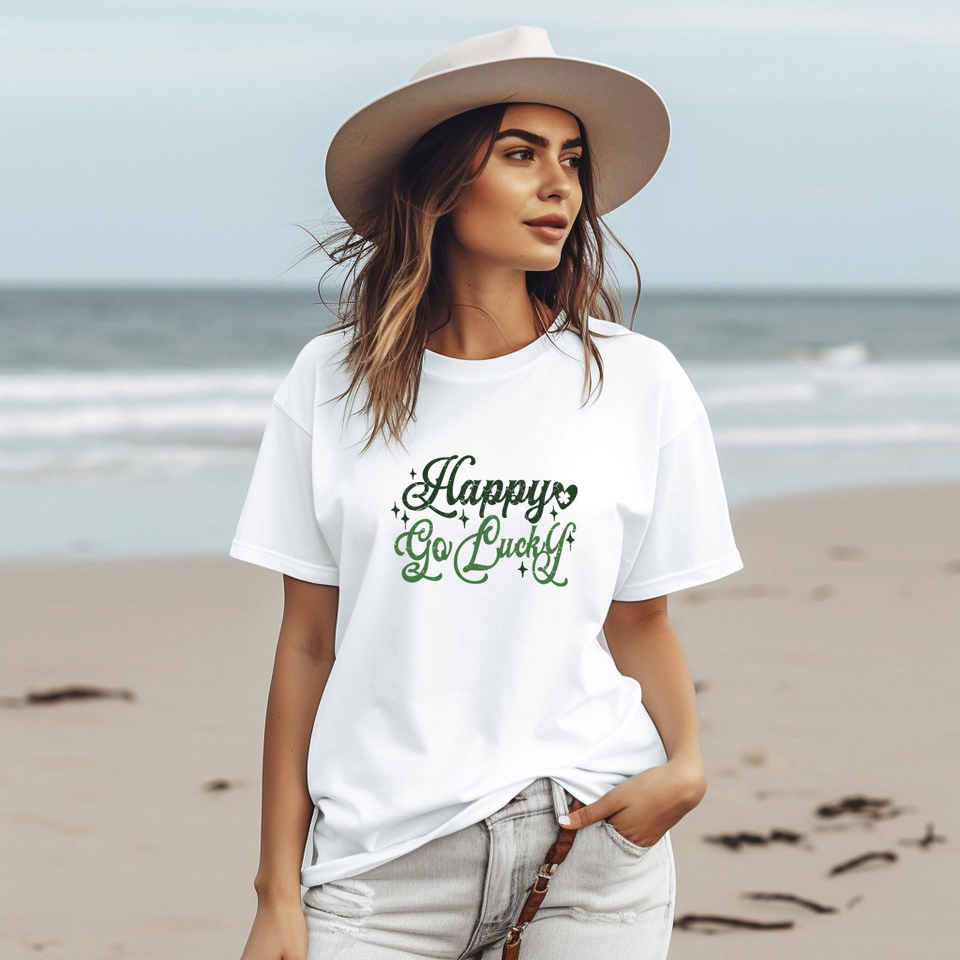 a woman standing on a beach wearing a hat