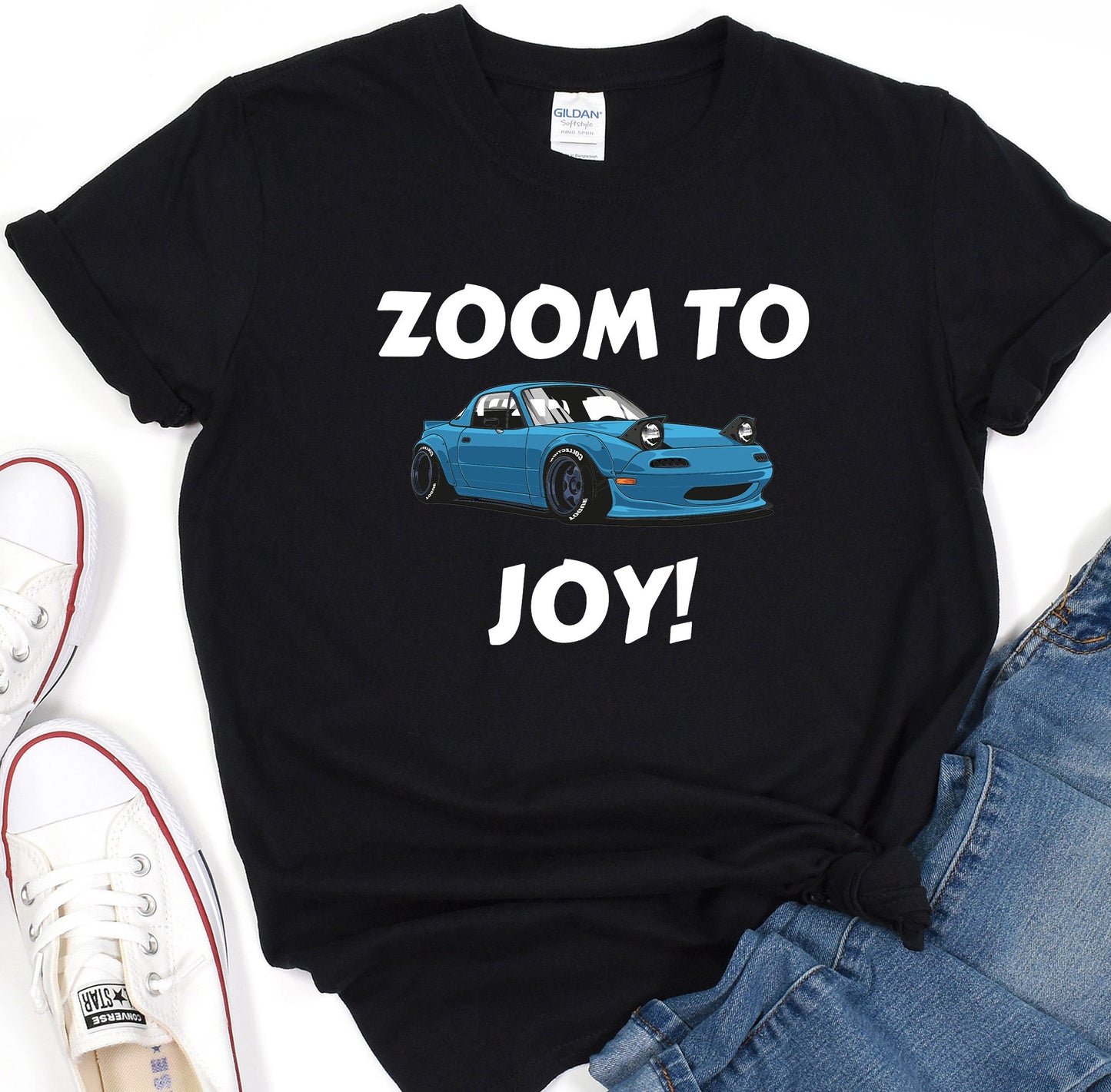 a black shirt with a blue car and the words zoom to joy on it