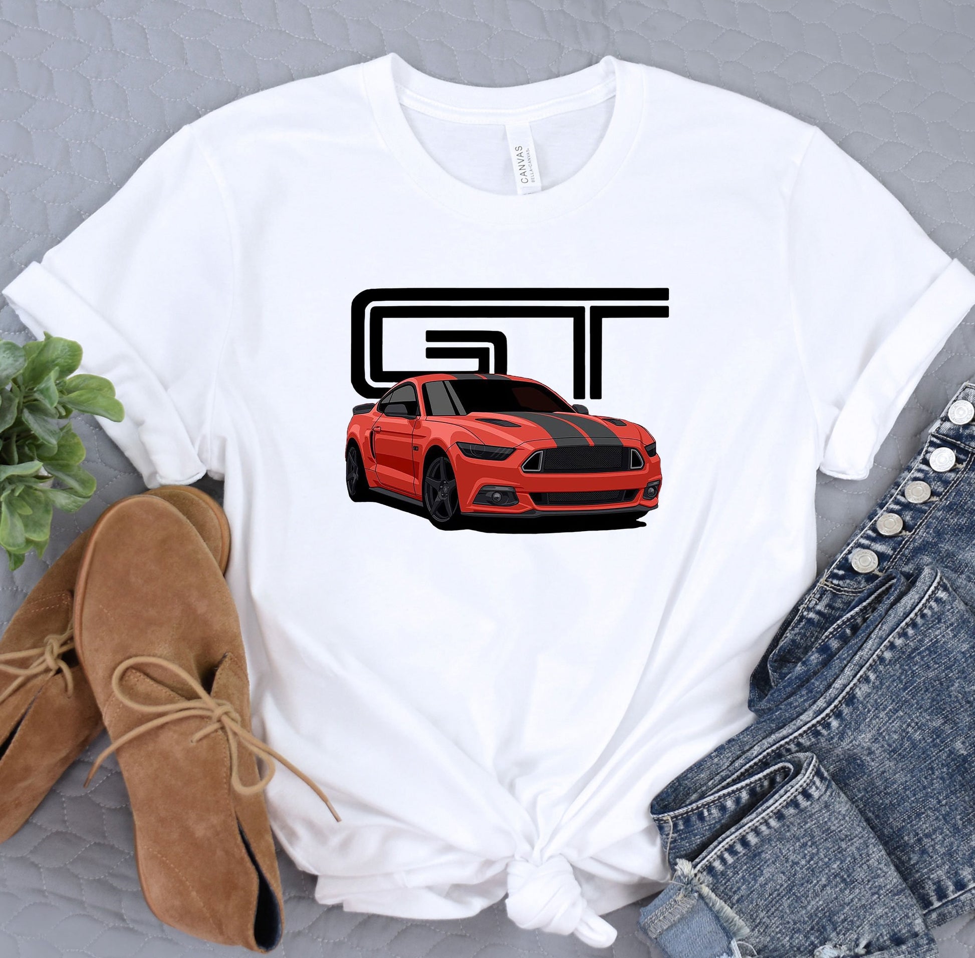 a white t - shirt with a red car on it