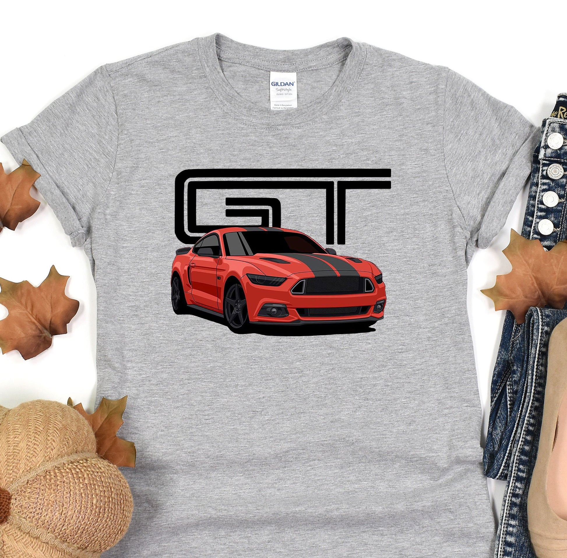 a grey t - shirt with a red mustang on it