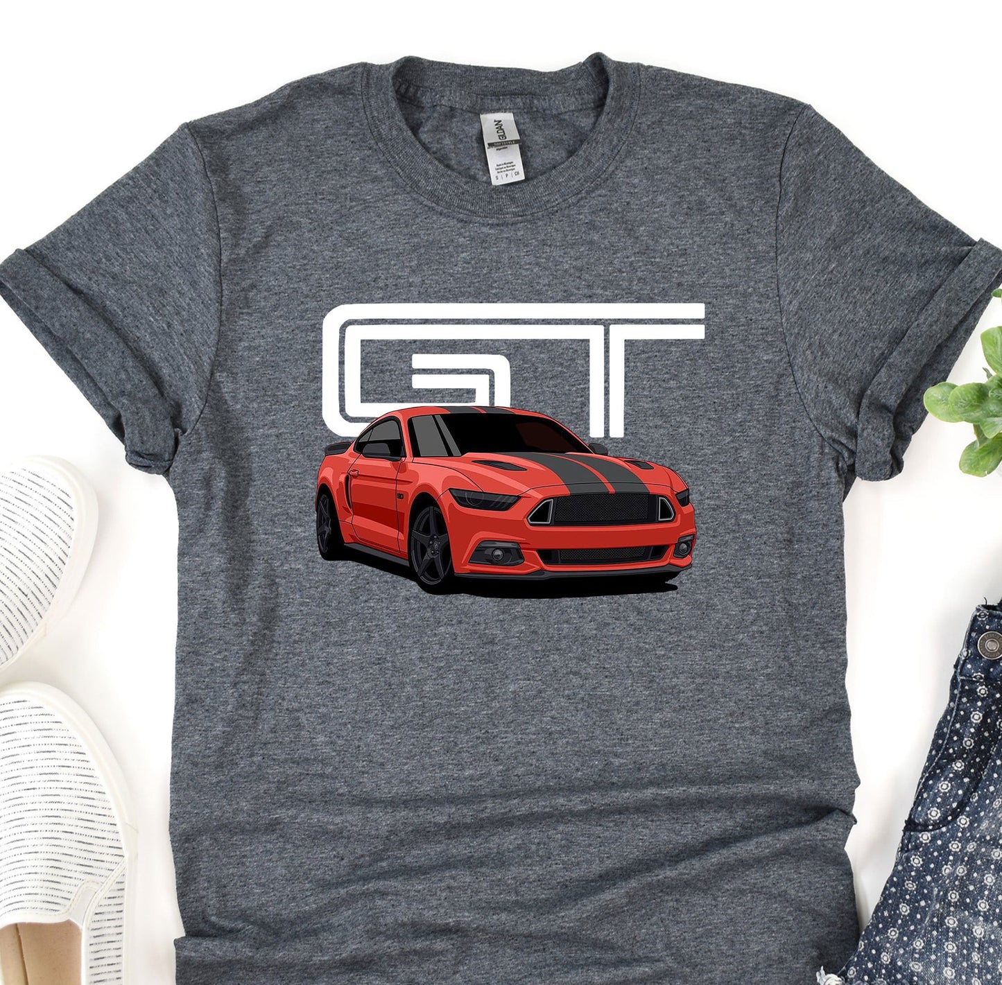 a t - shirt with a picture of a red mustang on it