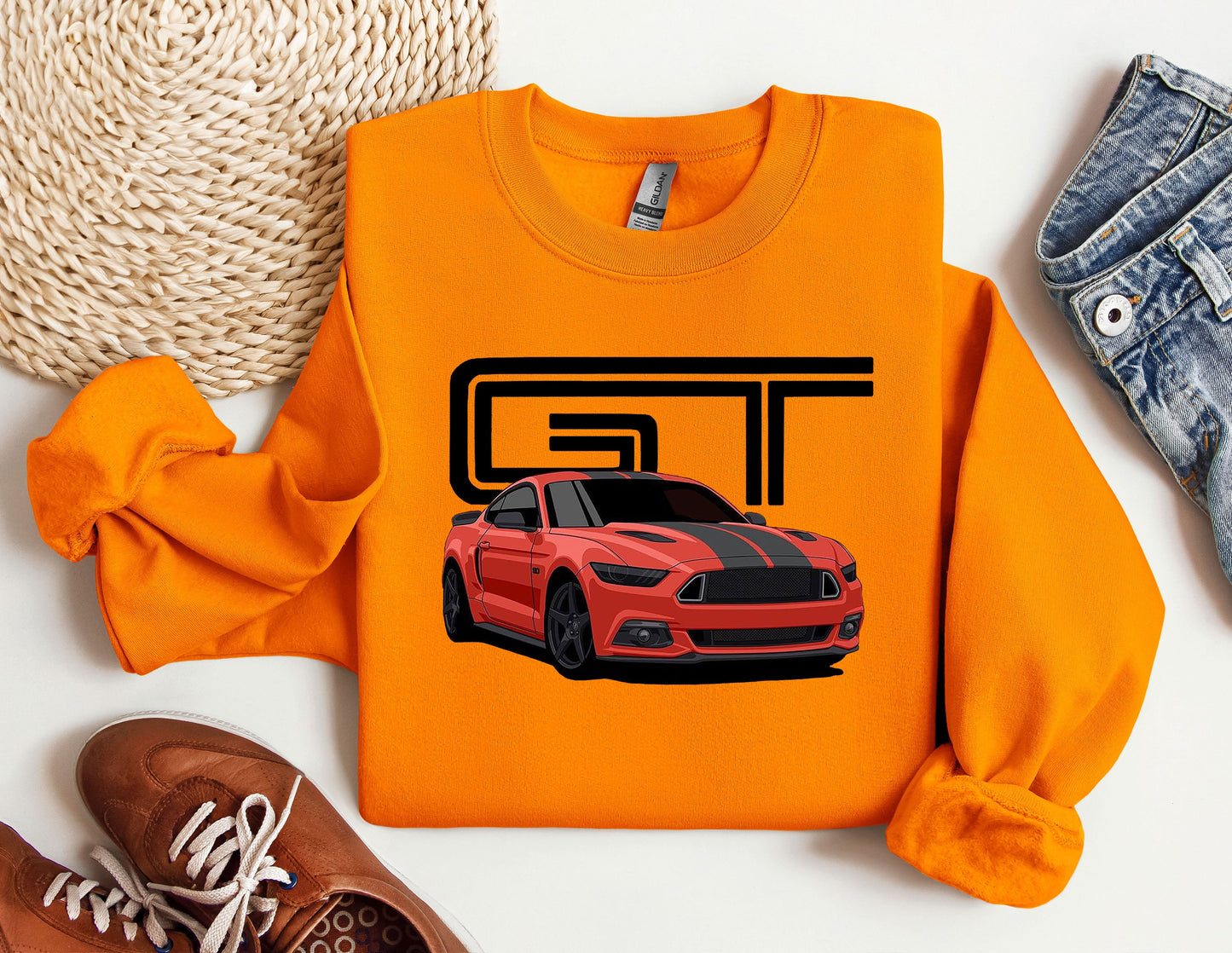 an orange sweatshirt with a picture of a car on it