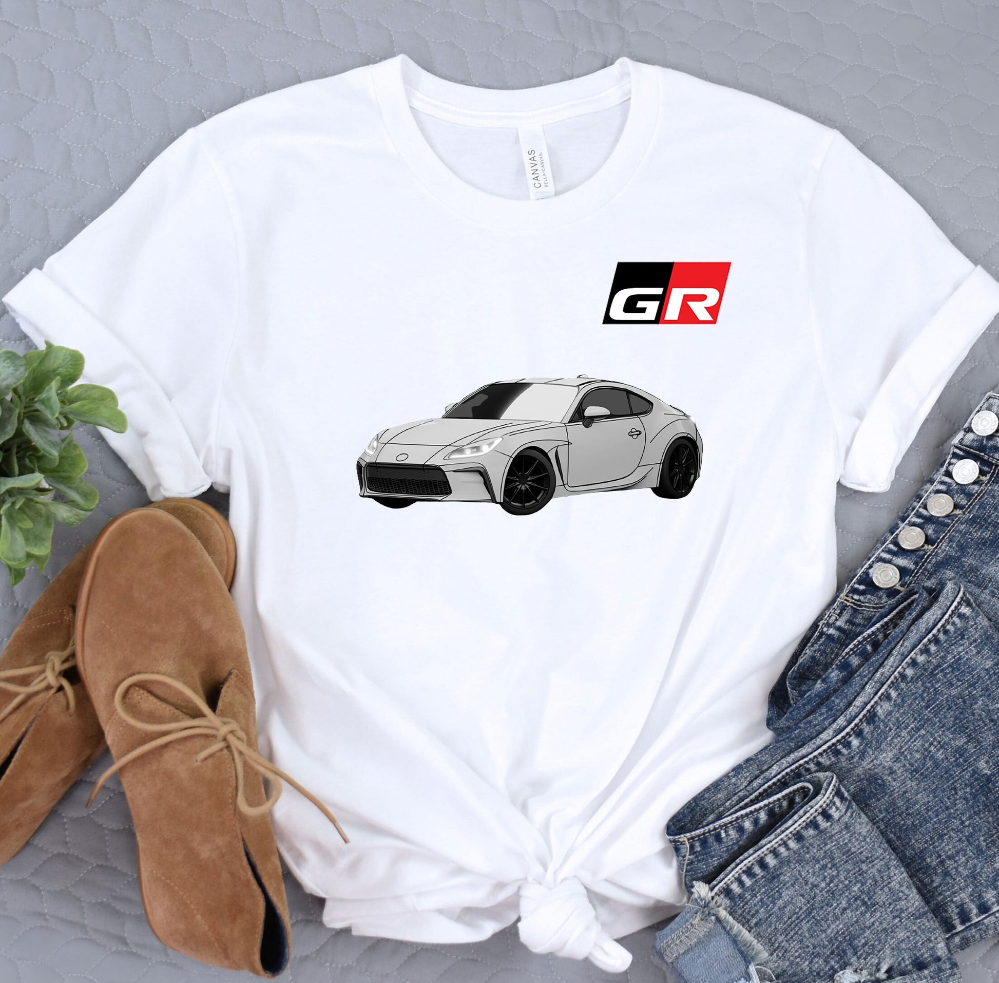 a white t - shirt with a picture of a car on it