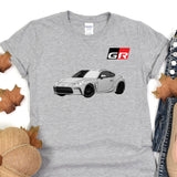 a gray t - shirt with a picture of a car on it