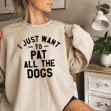 a woman wearing a sweatshirt that says i just want to pat all the dogs