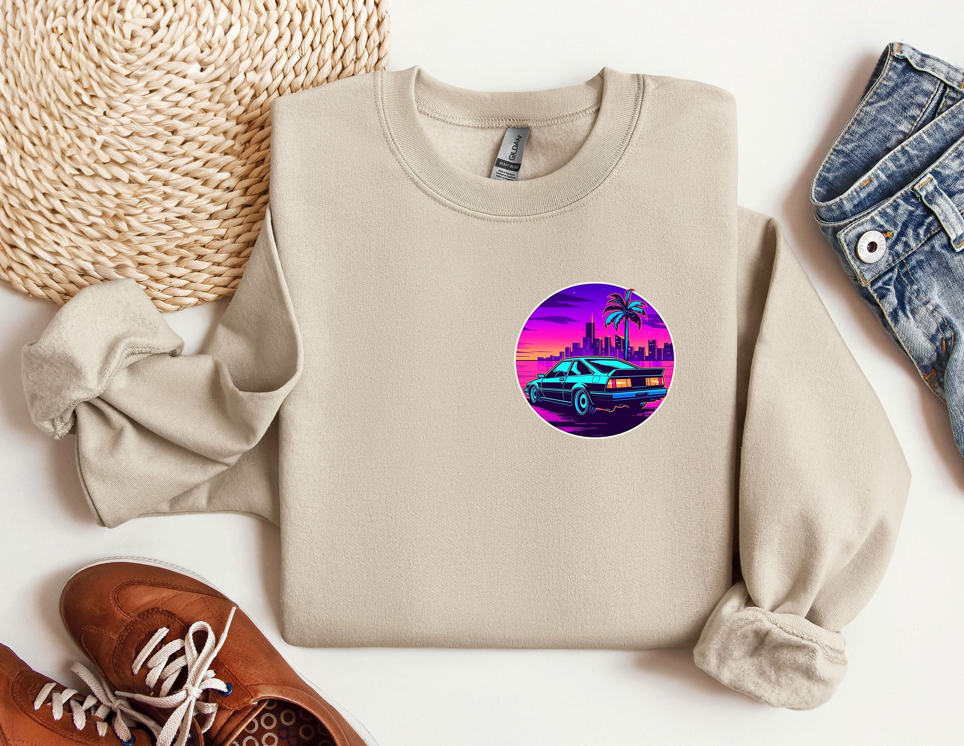 a sweater with a picture of a car and palm trees on it