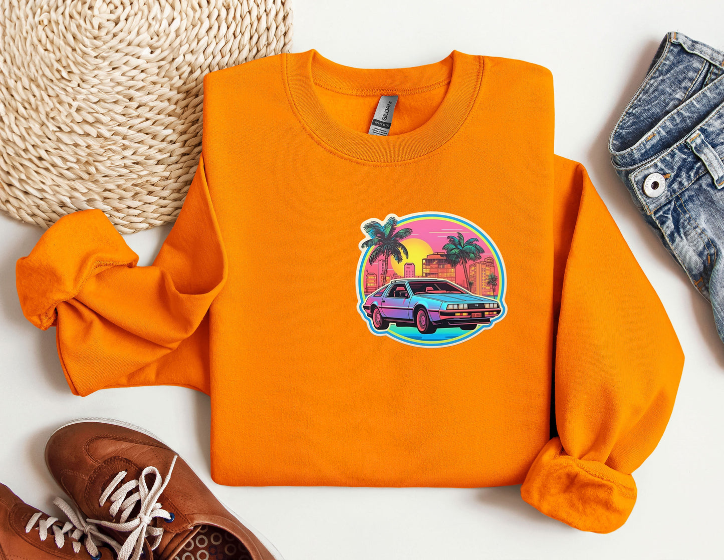 an orange sweatshirt with a picture of a car on it