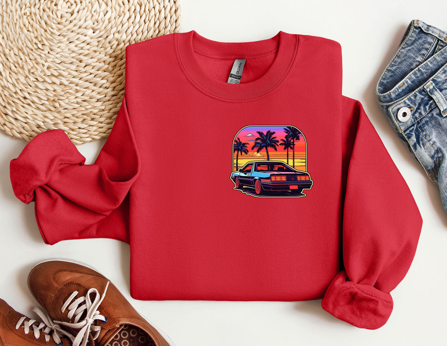 a red shirt with a picture of a car and palm trees