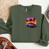 a green sweatshirt with a picture of a car and palm trees