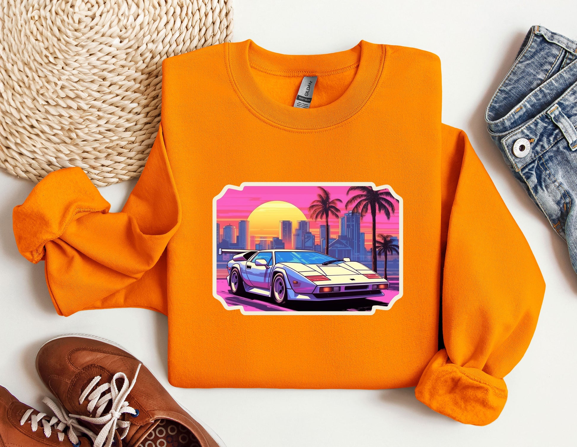 an orange sweatshirt with a picture of a car on it