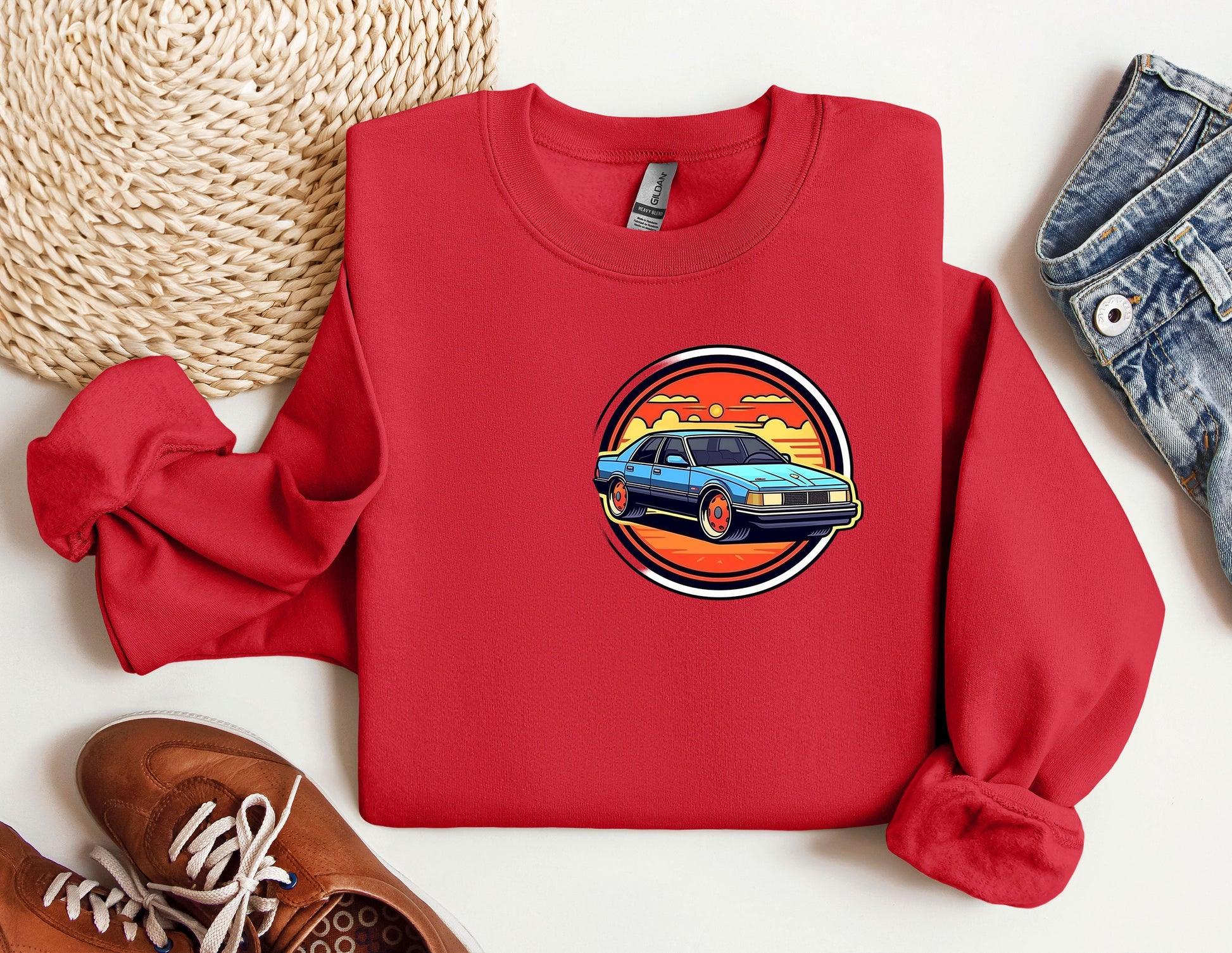 a red sweatshirt with a picture of a car on it