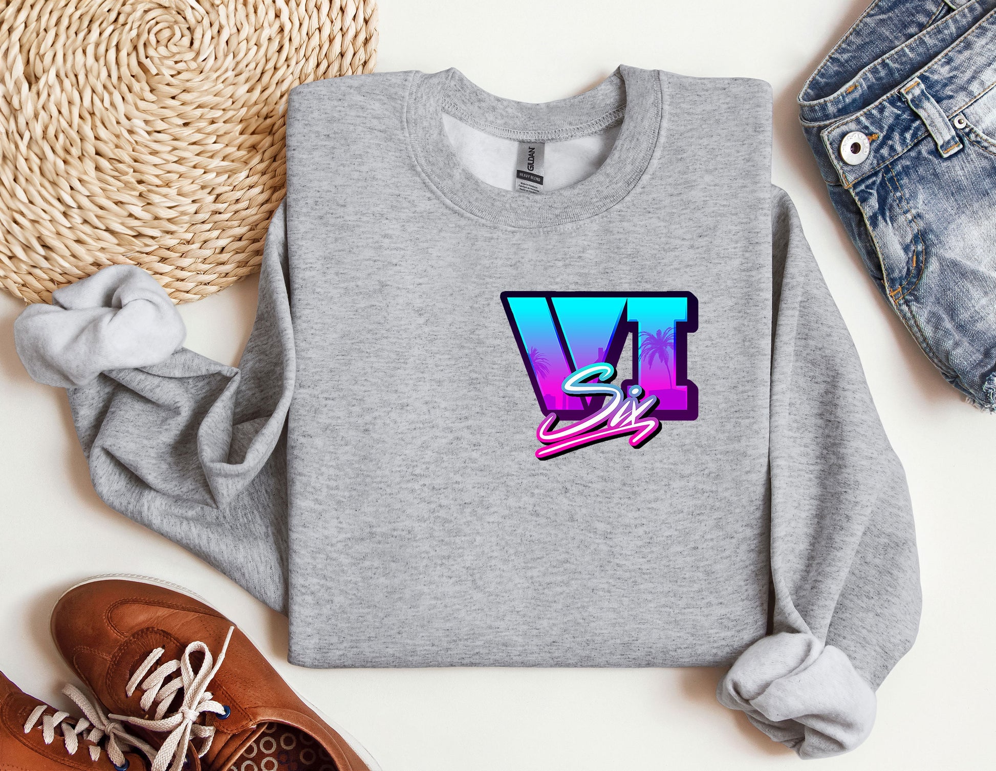 a sweatshirt with the letter v on it next to a pair of shoes