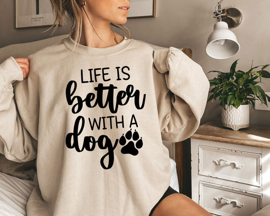 a woman wearing a sweatshirt that says life is better with a dog