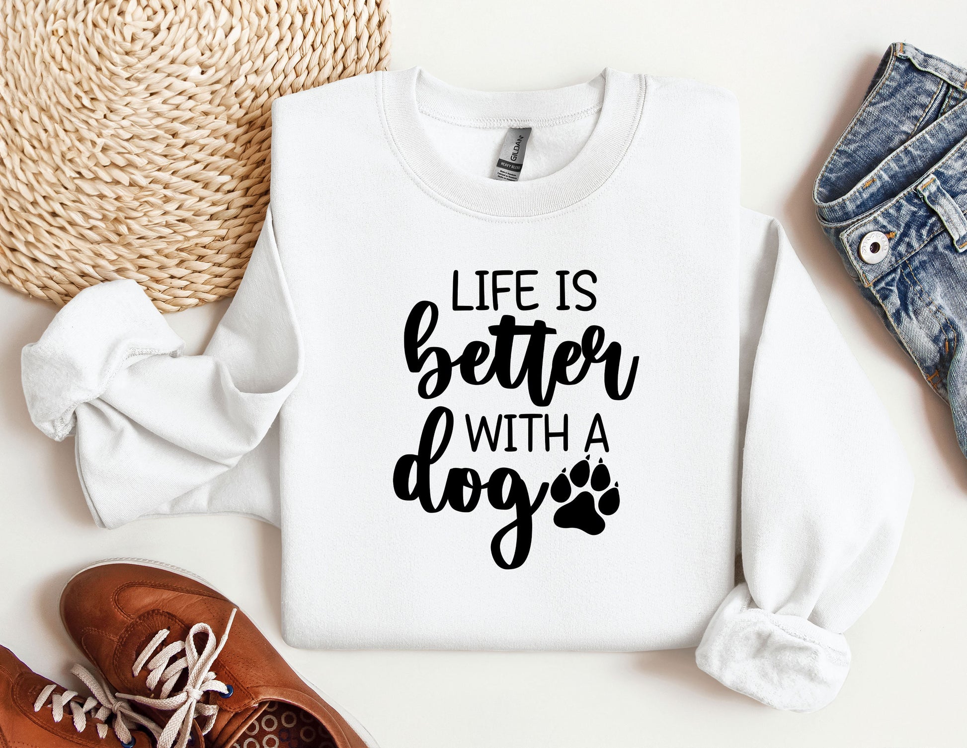 a sweater with a dog&#39;s paw on it next to a pair of shoes