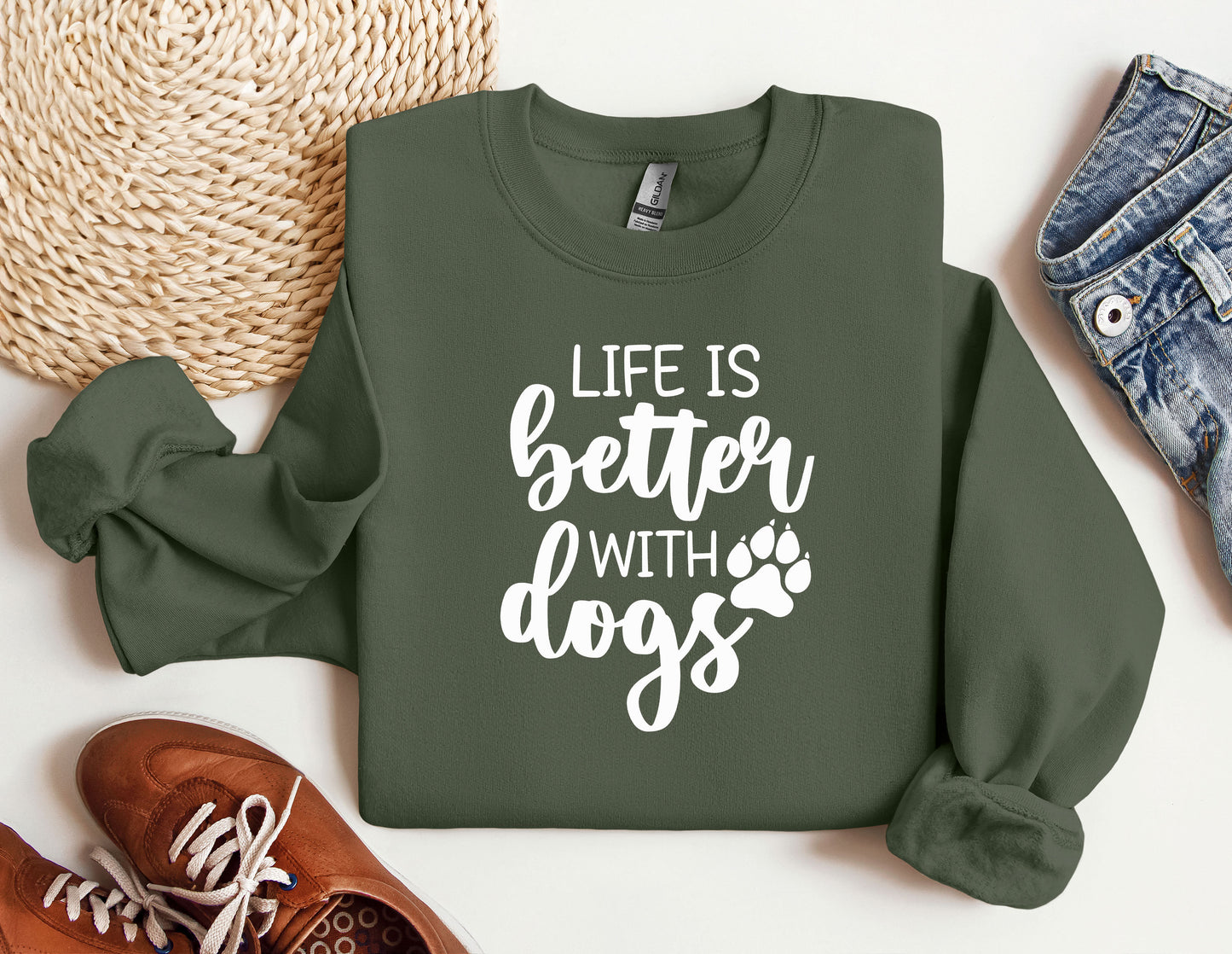 a green sweatshirt with the words life is better with dogs printed on it